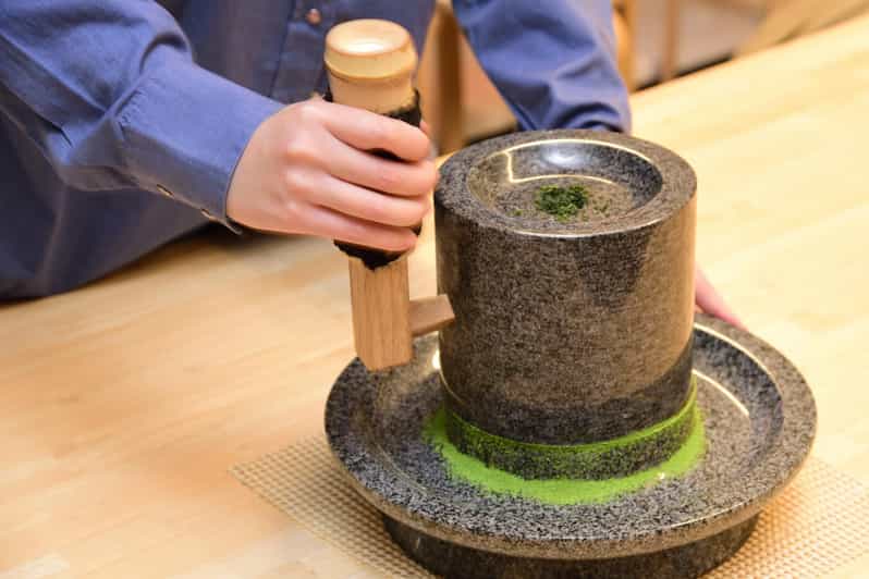 Kyoto: Tea Museum Tickets and Matcha Grinding Experience - Grinding tea the old-fashioned way at Chazuna
