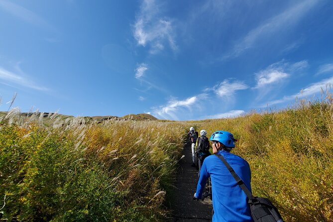 Private E-MTB guided cycling around Mt. Aso volcano & grasslands - Climbing Kusa no Michi through the grasslands