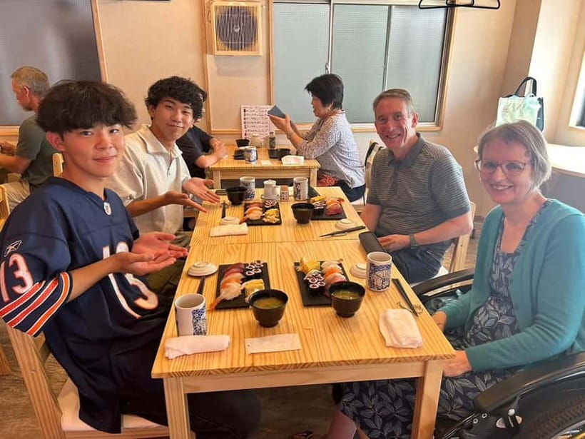 Tokyo: Tsukiji walk & sushi private tour with Uni Students - Starting beneath the stone facade of Tsukiji Hongwanji